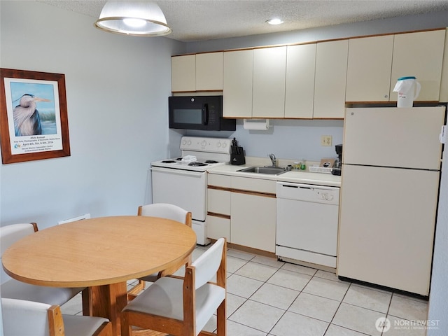 615 Ocean Shores Blvd NW Unit 115, Ocean Shores, WA 98569 - kitchen with white appliances, light countertops, a textured ceiling, and light tile patterned floors