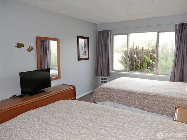 615 Ocean Shores Blvd NW Unit 115, Ocean Shores, WA 98569 - carpeted bedroom featuring baseboards and a textured ceiling