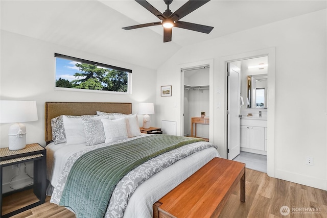 5945 41st Ave SW Unit A, Seattle, WA 98136 - bedroom with wood finished floors, vaulted ceiling, connected bathroom, ceiling fan, and a closet