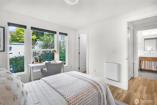 5945 41st Ave SW Unit A, Seattle, WA 98136 - bedroom with light wood finished floors and connected bathroom