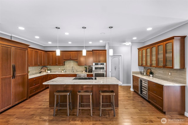 2620 Birch St, Bellingham, WA 98226 - kitchen featuring beverage cooler, a kitchen island, stainless steel double oven, backsplash, and a kitchen breakfast bar