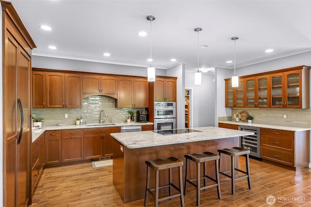 2620 Birch St, Bellingham, WA 98226 - kitchen with wine cooler, stainless steel appliances, crown molding, a center island, and light wood-type flooring