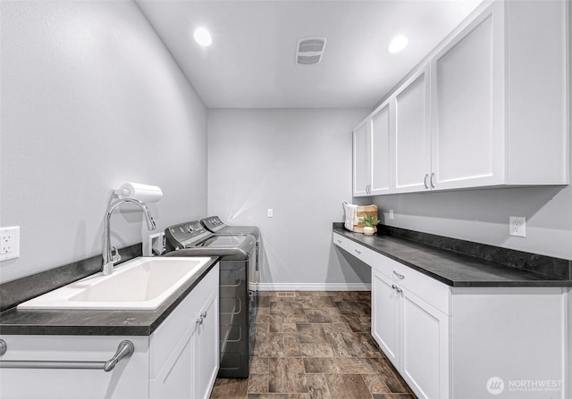 2620 Birch St, Bellingham, WA 98226 - washroom featuring stone finish flooring, independent washer and dryer, cabinet space, and recessed lighting