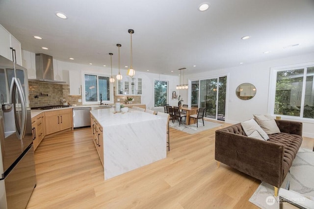 14737 56th Ave S, Tukwila, WA 98168 - kitchen with wall chimney exhaust hood, stainless steel appliances, light wood-style floors, decorative backsplash, and recessed lighting