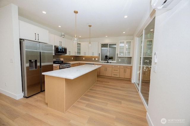 14737 56th Ave S, Tukwila, WA 98168 - kitchen with stainless steel appliances, decorative backsplash, glass insert cabinets, light wood-style floors, and recessed lighting