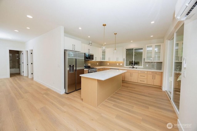 14737 56th Ave S, Tukwila, WA 98168 - kitchen featuring stainless steel appliances, an AC wall unit, backsplash, glass insert cabinets, and recessed lighting