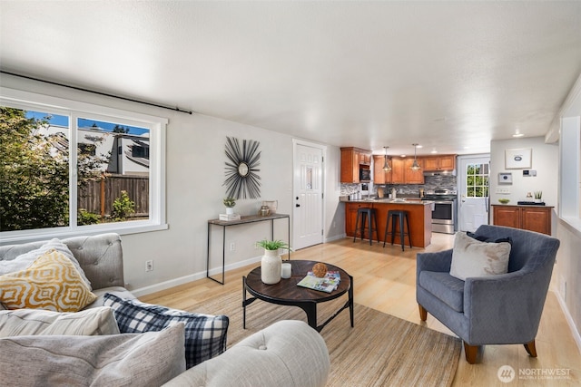 11432 11th Ave SW, Seattle, WA 98146 - living area featuring light wood-type flooring and baseboards