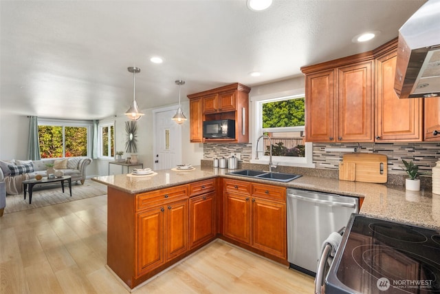 11432 11th Ave SW, Seattle, WA 98146 - kitchen featuring stainless steel dishwasher, black microwave, wall chimney range hood, range with electric cooktop, and a peninsula