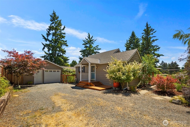 11432 11th Ave SW, Seattle, WA 98146 - view of property hidden behind natural elements with an outbuilding, a garage, and a shingled roof