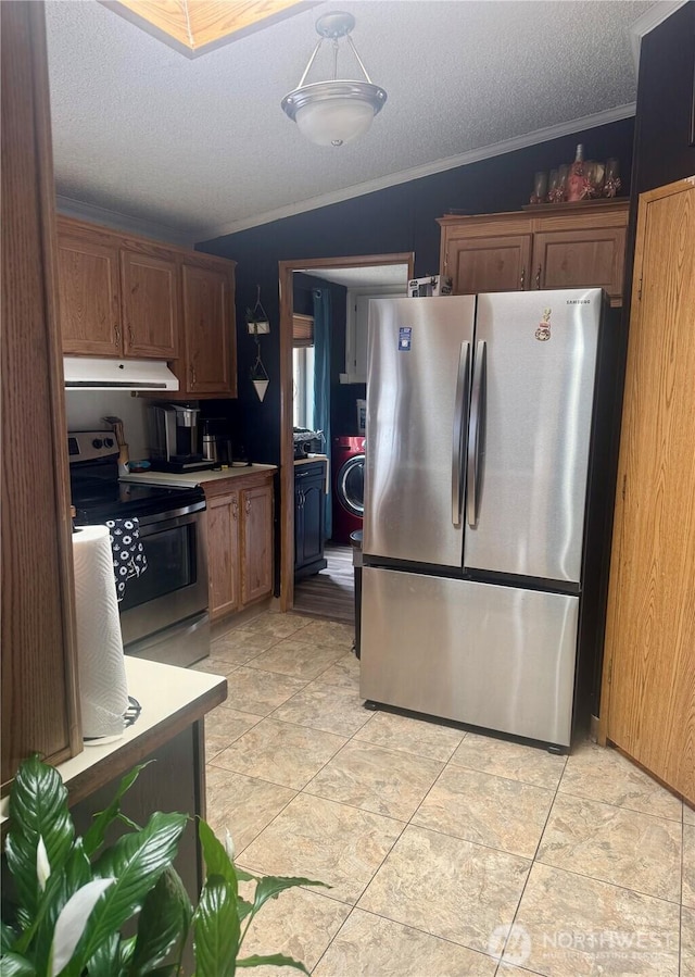 7619 156th Street Ct E Unit 9, Puyallup, WA 98375 - kitchen with stainless steel appliances, under cabinet range hood, crown molding, a textured ceiling, and brown cabinets