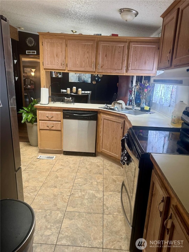 7619 156th Street Ct E Unit 9, Puyallup, WA 98375 - kitchen featuring electric range oven, dishwasher, under cabinet range hood, light countertops, and a textured ceiling