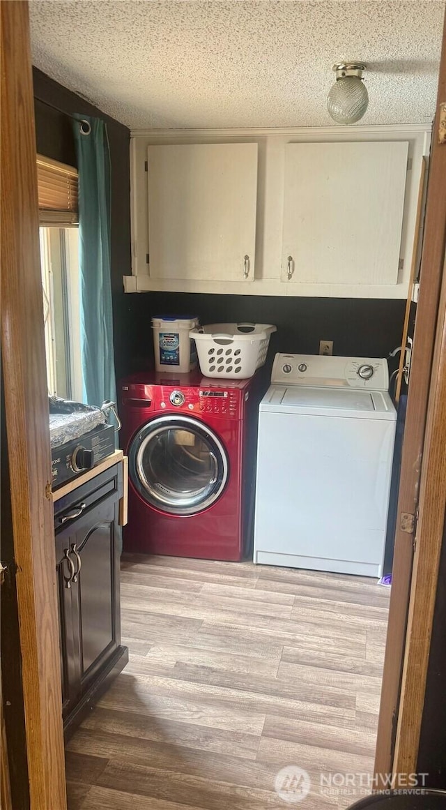 7619 156th Street Ct E Unit 9, Puyallup, WA 98375 - washroom featuring washing machine and dryer, cabinet space, wood finished floors, and a textured ceiling