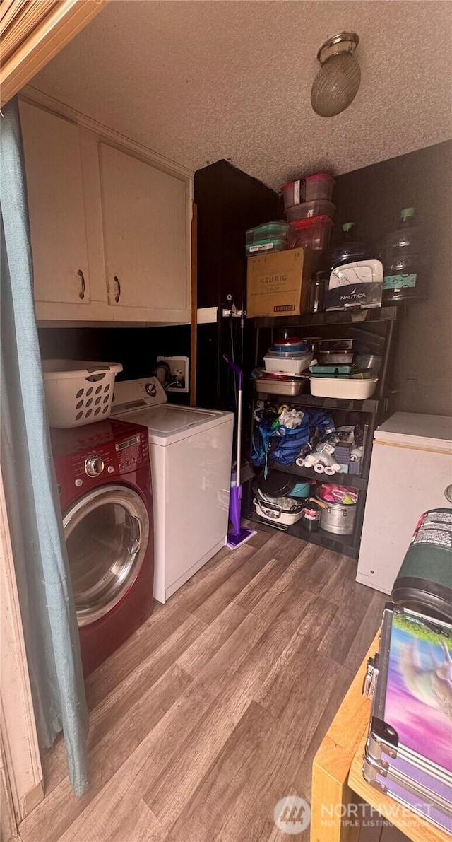 7619 156th Street Ct E Unit 9, Puyallup, WA 98375 - laundry area with washing machine and clothes dryer, wood finished floors, cabinet space, and a textured ceiling