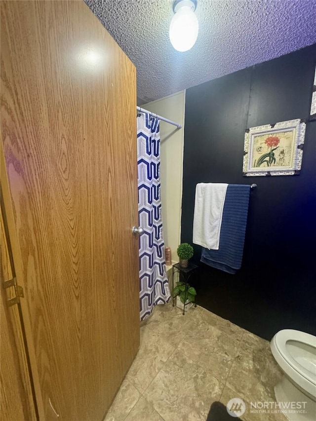 7619 156th Street Ct E Unit 9, Puyallup, WA 98375 - bathroom featuring a textured ceiling and a shower with curtain