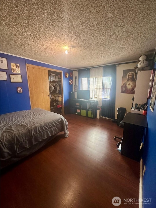 7619 156th Street Ct E Unit 9, Puyallup, WA 98375 - bedroom with a textured ceiling, wood finished floors, and a desk