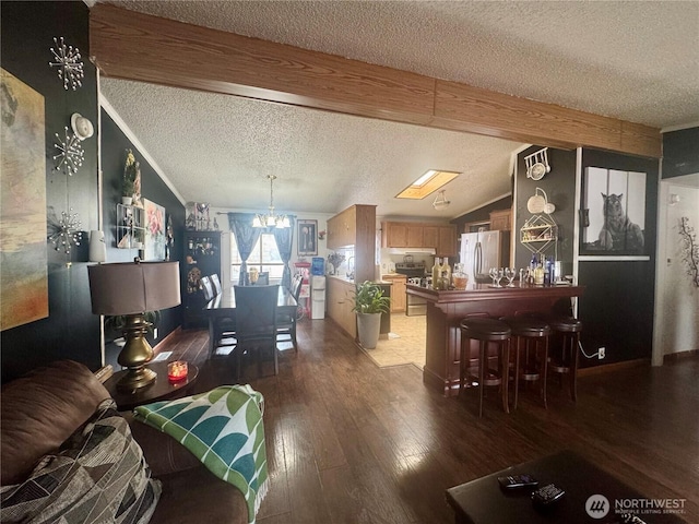 7619 156th Street Ct E Unit 9, Puyallup, WA 98375 - living room with a textured ceiling, a chandelier, and hardwood / wood-style flooring