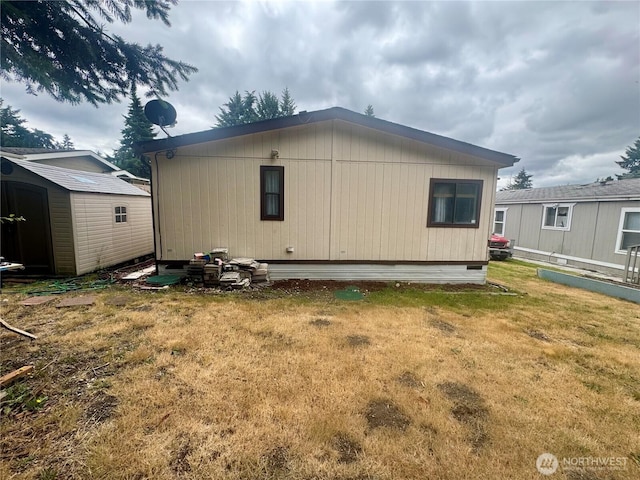 7619 156th Street Ct E Unit 9, Puyallup, WA 98375 - back of property with a storage unit and a lawn