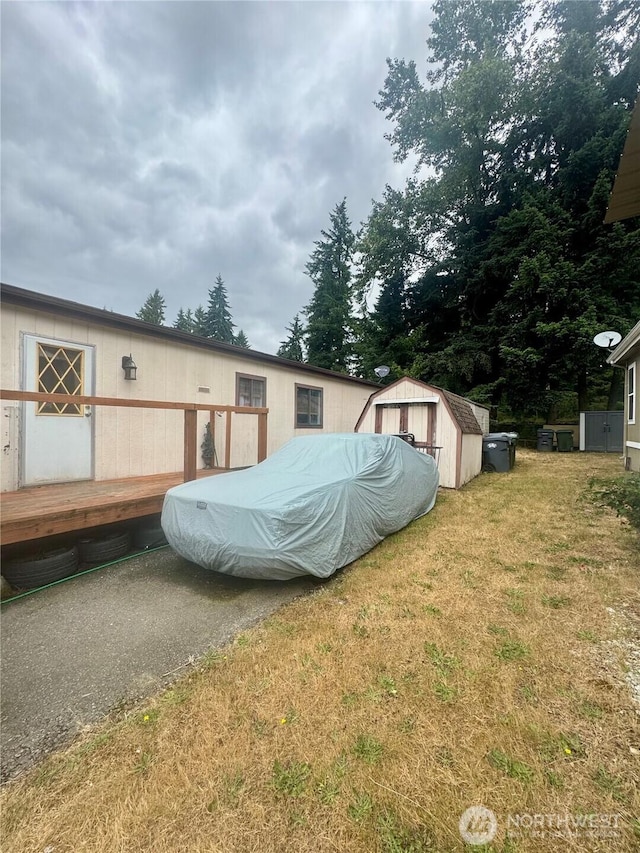 7619 156th Street Ct E Unit 9, Puyallup, WA 98375 - view of property exterior with a storage unit, a yard, and a deck