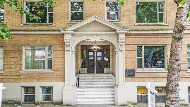 7 Harrison St Unit 5, Seattle, WA 98109 - view of exterior entry featuring brick siding and french doors