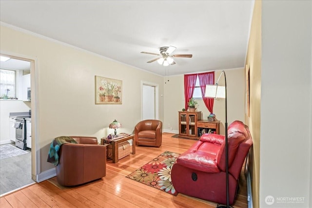 7 Harrison St Unit 5, Seattle, WA 98109 - living room with a ceiling fan, light wood-style flooring, crown molding, and plenty of natural light