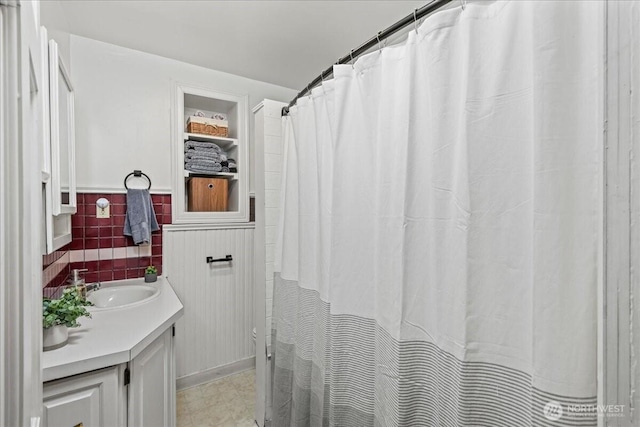 7 Harrison St Unit 5, Seattle, WA 98109 - bathroom with vanity, tile walls, and a wainscoted wall
