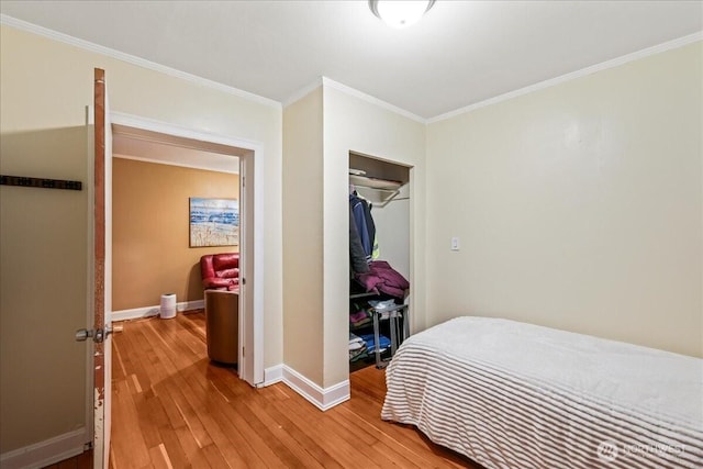 7 Harrison St Unit 5, Seattle, WA 98109 - bedroom with light wood-type flooring, crown molding, and a closet