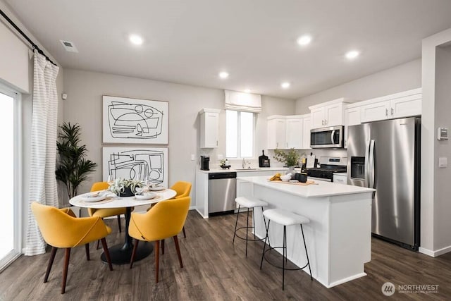 224 18th Dr Unit 96, Snohomish, WA 98290 - kitchen with stainless steel appliances, a kitchen island, dark wood finished floors, white cabinets, and light countertops