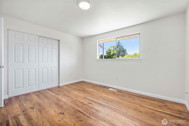 11613 63rd Street Ct E, Puyallup, WA 98372 - unfurnished bedroom featuring a closet and light wood finished floors