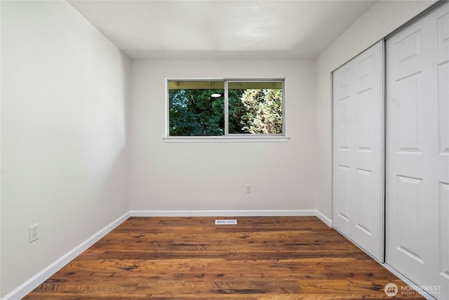 11613 63rd Street Ct E, Puyallup, WA 98372 - unfurnished bedroom with dark wood-type flooring and a closet