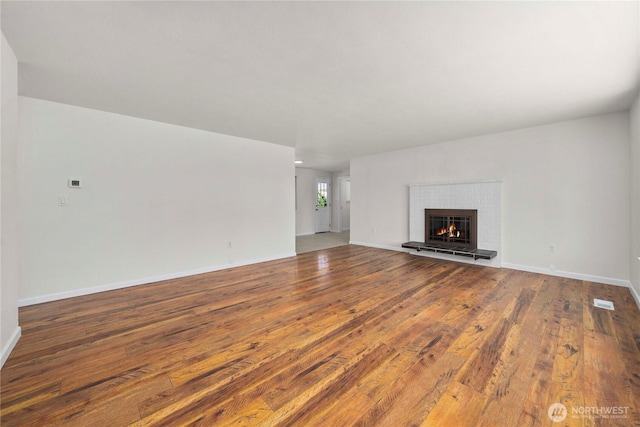 11613 63rd Street Ct E, Puyallup, WA 98372 - unfurnished living room featuring wood-type flooring and a tile fireplace