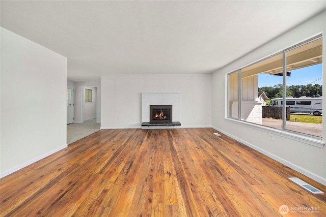 11613 63rd Street Ct E, Puyallup, WA 98372 - unfurnished living room featuring wood-type flooring and a brick fireplace