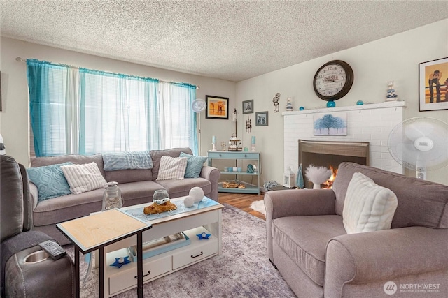 11613 63rd Street Ct E, Puyallup, WA 98372 - living area featuring a textured ceiling, a brick fireplace, and wood finished floors
