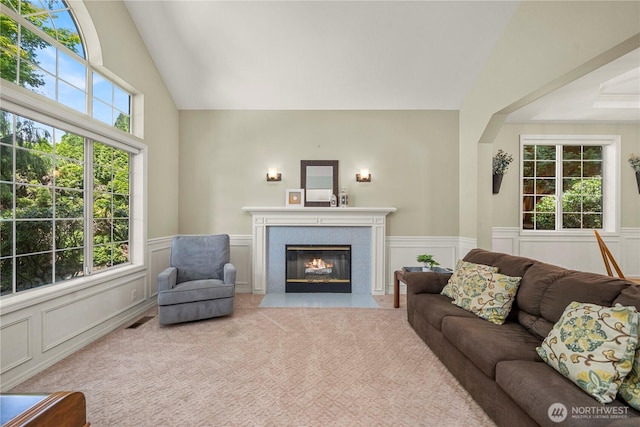 30449 103rd Ct SE, Auburn, WA 98092 - living room featuring a decorative wall, a fireplace, a wainscoted wall, lofted ceiling, and carpet floors