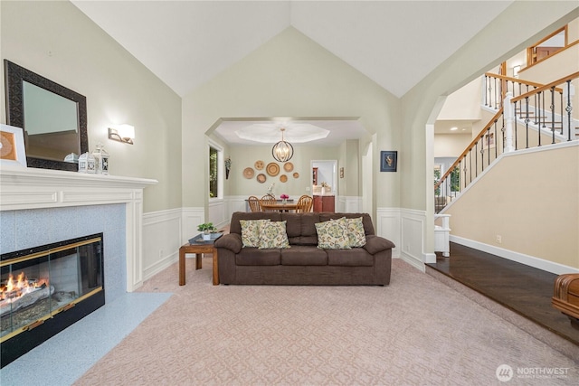 30449 103rd Ct SE, Auburn, WA 98092 - living area with carpet flooring, stairway, wainscoting, a glass covered fireplace, and arched walkways