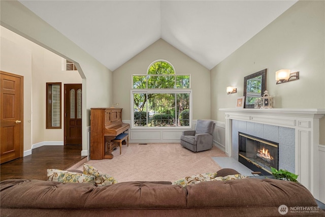 30449 103rd Ct SE, Auburn, WA 98092 - living room featuring a tile fireplace, high vaulted ceiling, wood finished floors, and arched walkways