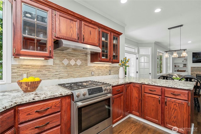 30449 103rd Ct SE, Auburn, WA 98092 - kitchen featuring stainless steel gas stove, under cabinet range hood, ornamental molding, a peninsula, and dark wood-style flooring