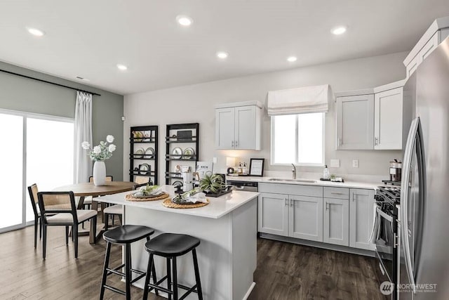 214 18th Dr Unit 100, Snohomish, WA 98290 - kitchen featuring range with gas cooktop, freestanding refrigerator, dark wood finished floors, light countertops, and recessed lighting
