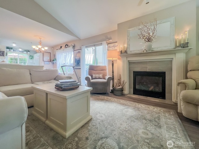 38774 SE Beta, Unit Snoqualmie, WA 98065 - living area featuring lofted ceiling, a chandelier, a glass covered fireplace, and wood finished floors