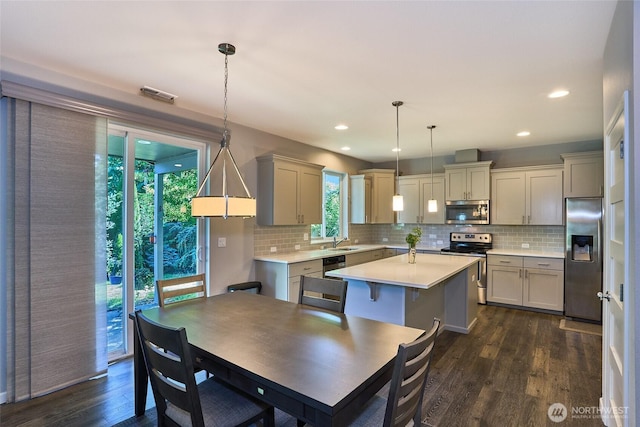 12235 SE 253rd St, Kent, WA 98030 - kitchen with appliances with stainless steel finishes, light countertops, tasteful backsplash, dark wood finished floors, and recessed lighting
