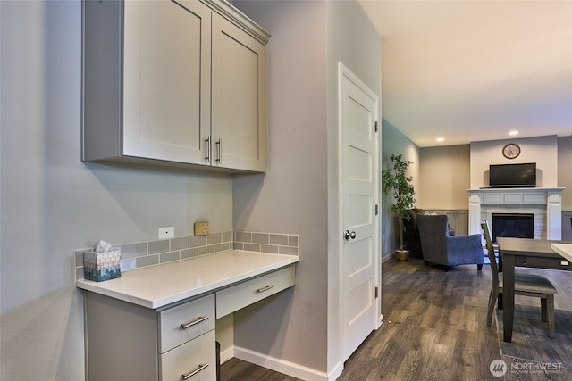 12235 SE 253rd St, Kent, WA 98030 - kitchen featuring gray cabinets, dark wood-style flooring, a glass covered fireplace, light countertops, and recessed lighting