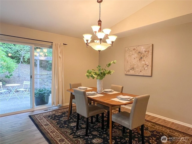 104 Puget Loop, Port Ludlow, WA 98365 - dining space featuring wood finished floors, a chandelier, and vaulted ceiling
