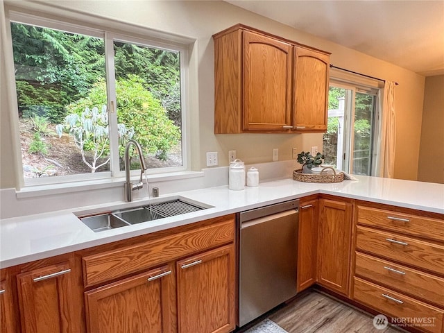 104 Puget Loop, Port Ludlow, WA 98365 - kitchen with dishwasher, light countertops, brown cabinets, and light wood-style flooring