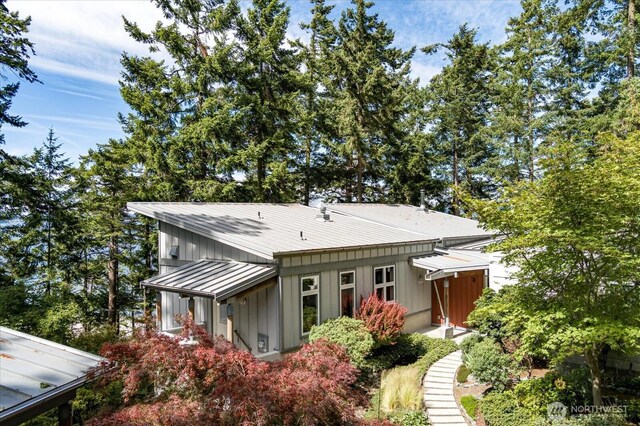 222 Rhodena Dr, Coupeville, WA 98239 - rear view of house featuring board and batten siding, a metal roof, and a standing seam roof