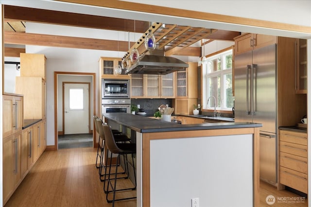222 Rhodena Dr, Coupeville, WA 98239 - kitchen with built in appliances, range hood, dark countertops, healthy amount of natural light, and beamed ceiling