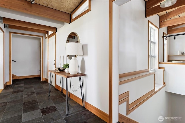 222 Rhodena Dr, Coupeville, WA 98239 - hallway featuring beam ceiling and dark stone finish floors