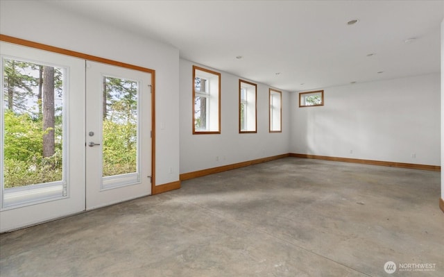 222 Rhodena Dr, Coupeville, WA 98239 - spare room with concrete floors, french doors, and plenty of natural light