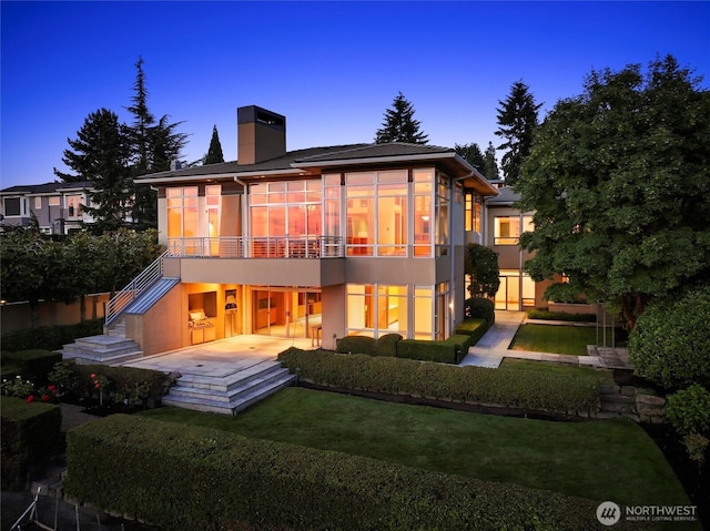 5511 104th Ave NE, Kirkland, WA 98033 - rear view of property featuring a chimney, a sunroom, stairway, a patio, and a yard