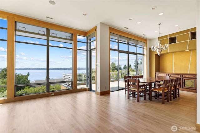 5511 104th Ave NE, Kirkland, WA 98033 - dining area featuring floor to ceiling windows, light wood-type flooring, a water view, a chandelier, and recessed lighting