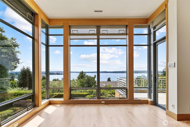 5511 104th Ave NE, Kirkland, WA 98033 - unfurnished sunroom featuring a water view and wood finished floors