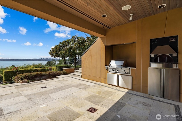 5511 104th Ave NE, Kirkland, WA 98033 - view of patio with exterior kitchen and a water view